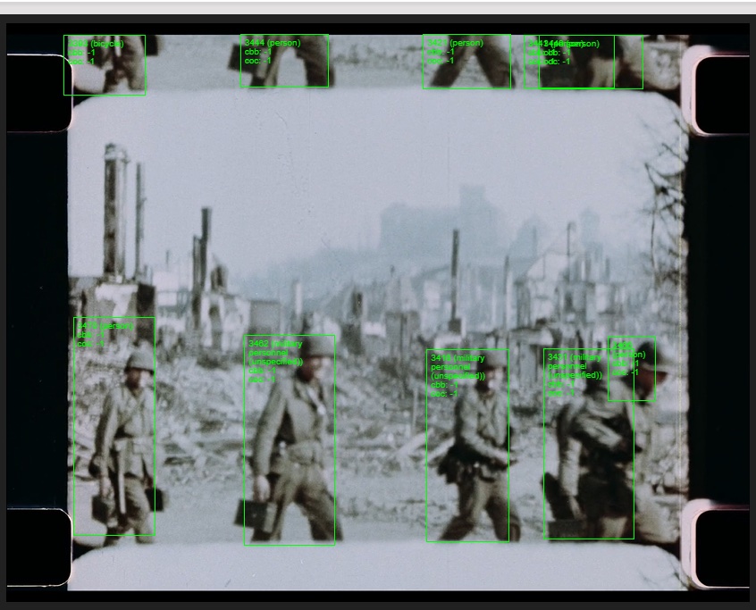 Scan of filmstrip showing soldiers walking past ruins. Green rectangles mark up the figures.