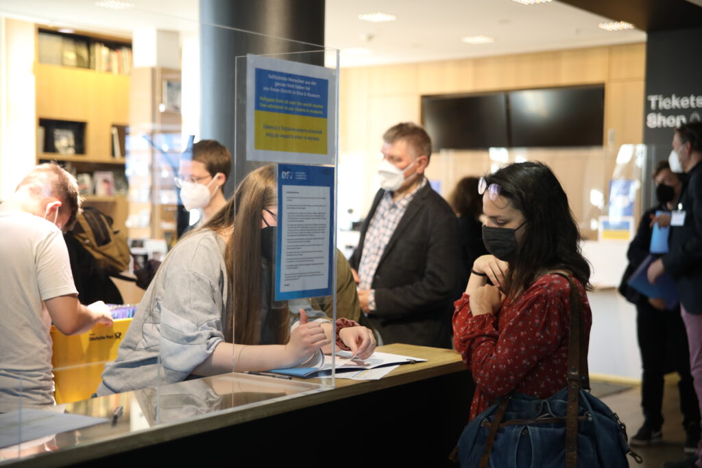 This photo shows several participants of the conference during registration.