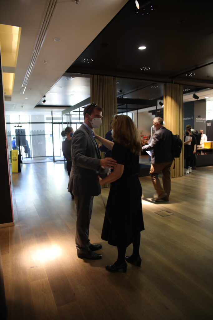 This photo shows a man and a woman greeting one another.