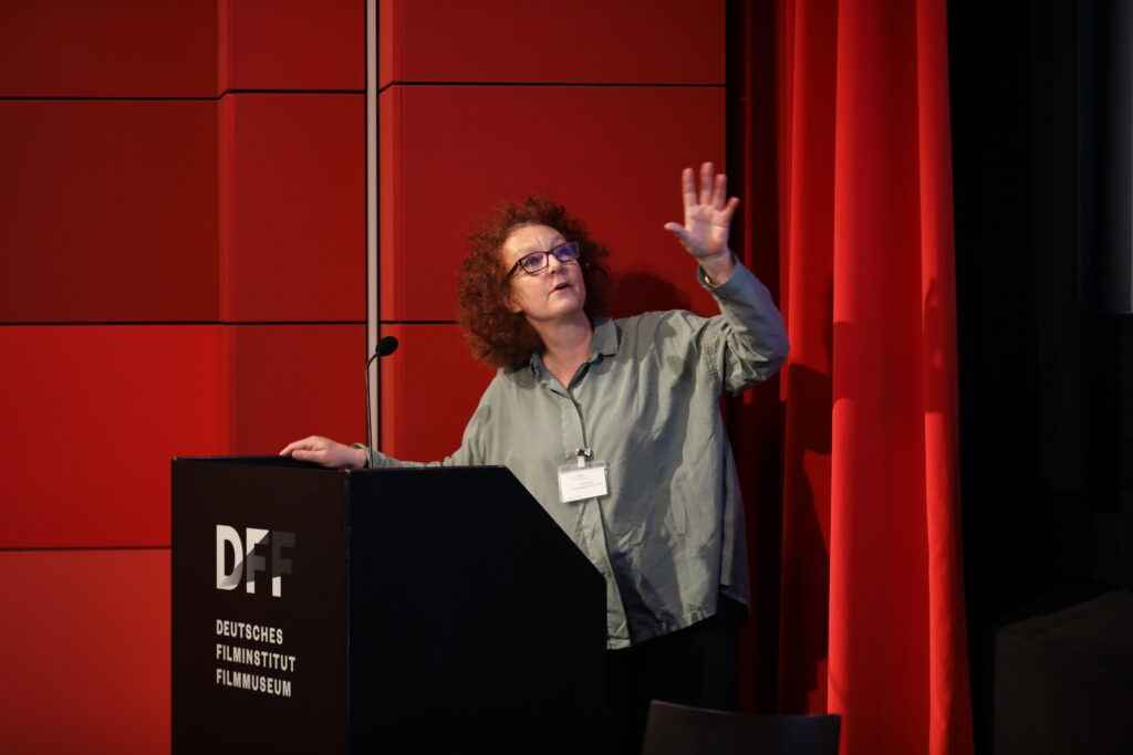 This photo shows a woman explaining and gesturing.