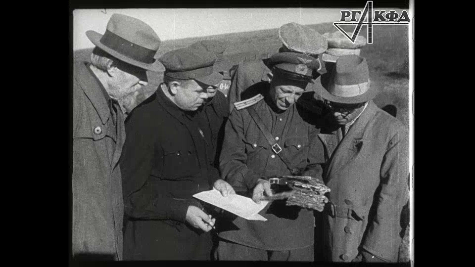 This event poster features a film still showing four men, one in uniform and three in civilian clothes, probably examining evidence.